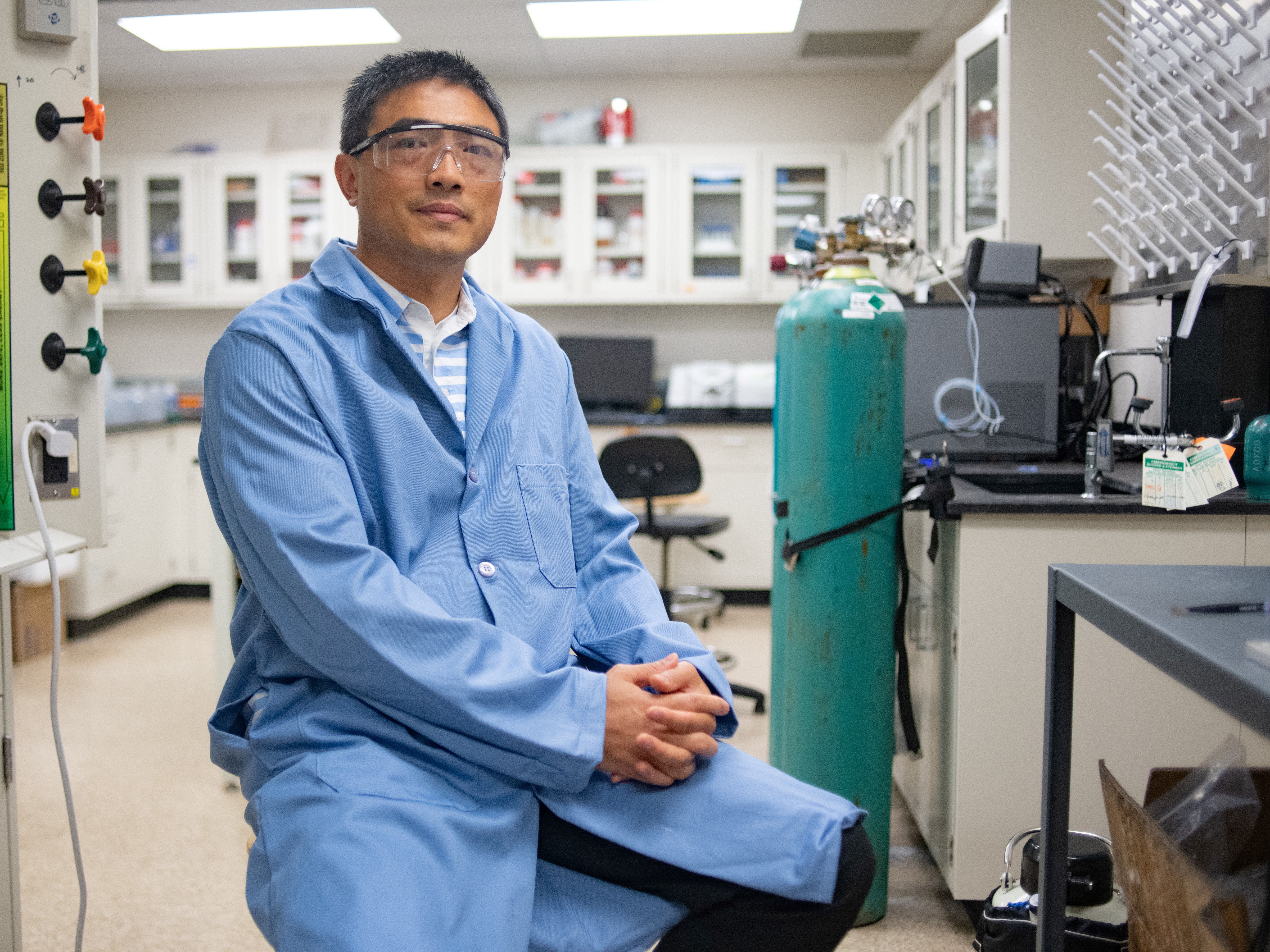 UT Austin Texas engineering professor Guihua Yu smiling in his research lab