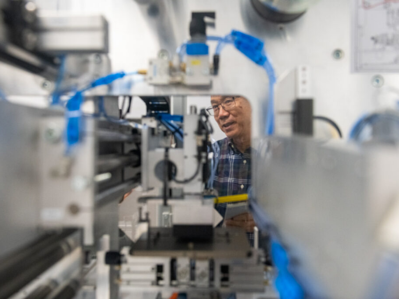 Texas Engineer looking through piece of lab equipment