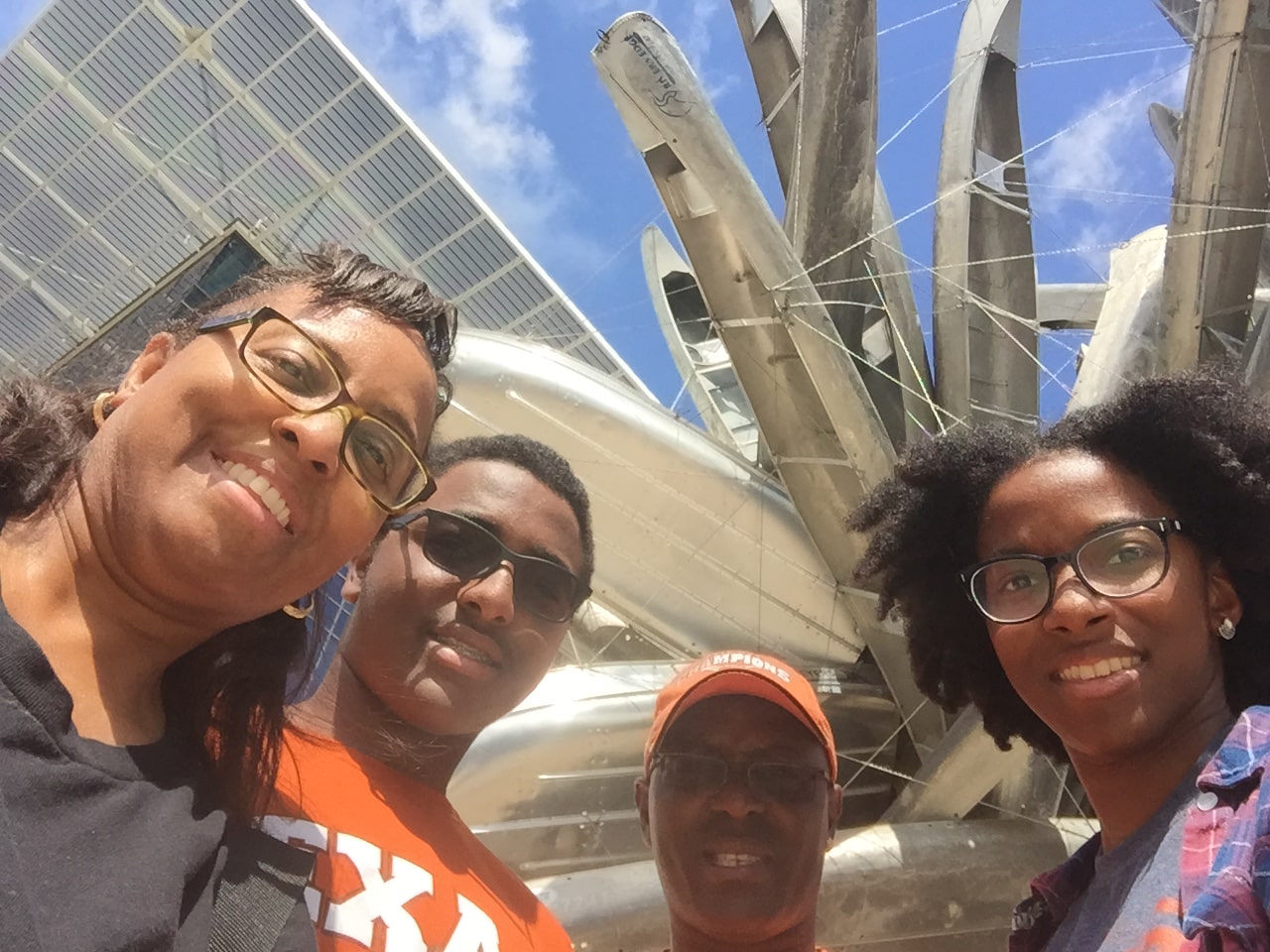 Cassel family smiling in front of UT Austin canoe sculpture