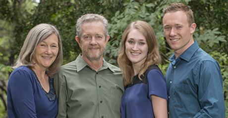 UT Austin alumni Osborne and Cecilia Green smiling with their children