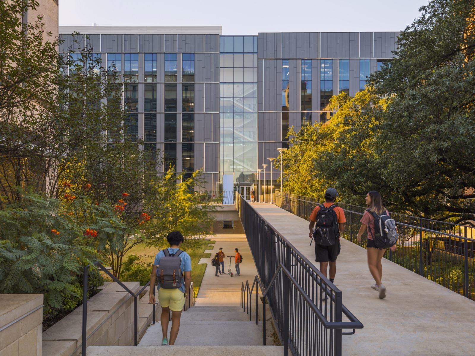 students walking on the UT Austin campus at sunset