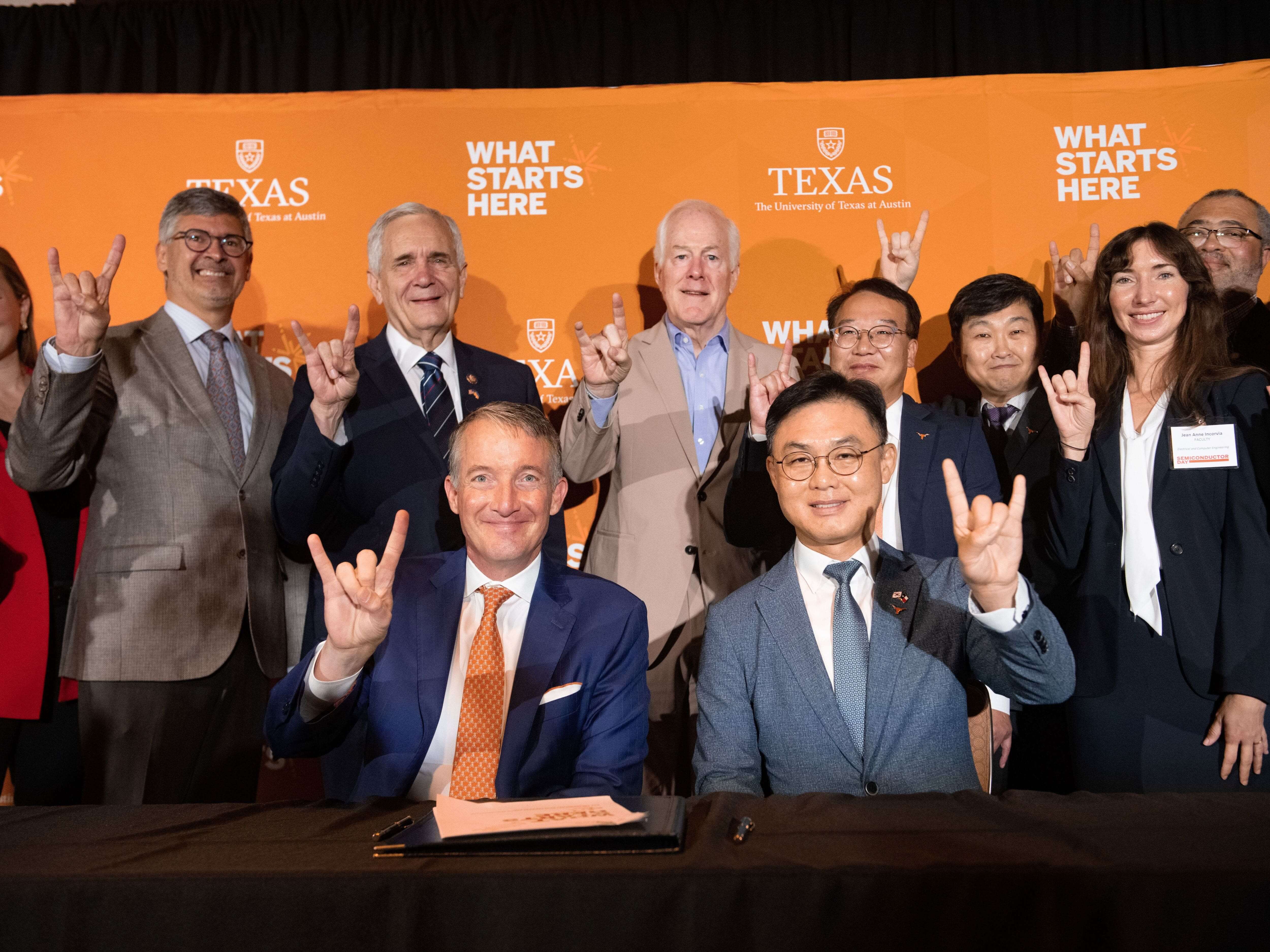 UT Austin leadership and Semiconductor Day speakers doing hook 'em horns hand signs