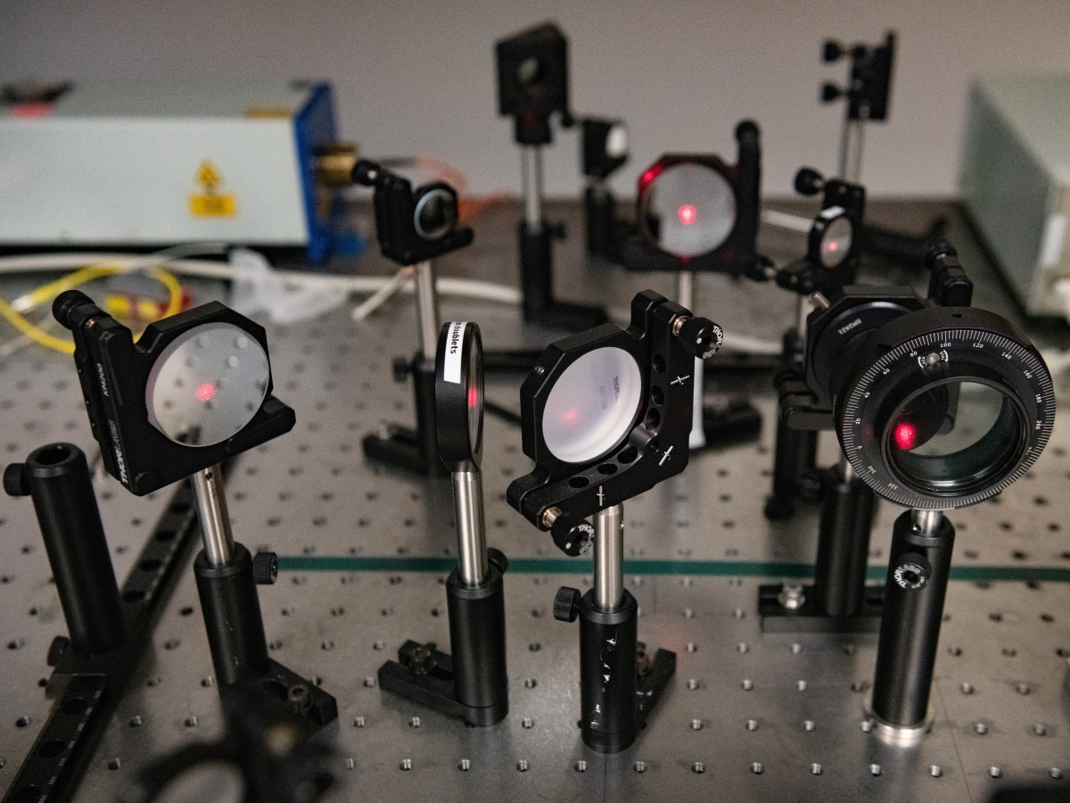 Mirrors and prisms in Yuebing Zheng's lab at The University of Texas at Austin direct laser