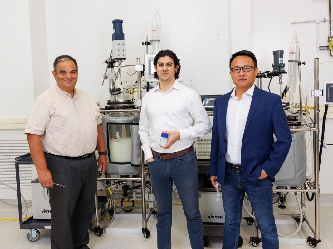 Alex Girau, Leigang Xue smiling with Tx engineer in John Goodenough lab