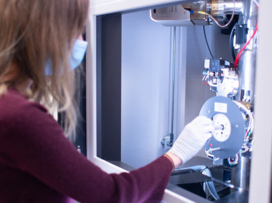 student in lab working on desalination membrane