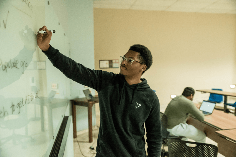 Texas engineering student writing on whiteboard