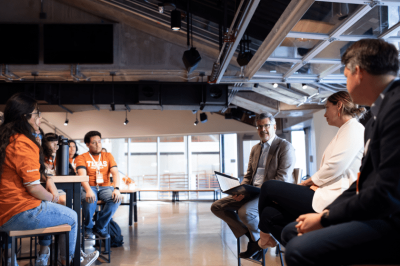 Dean Roger Bonnecaze talking to Texas engineering students in a hallway