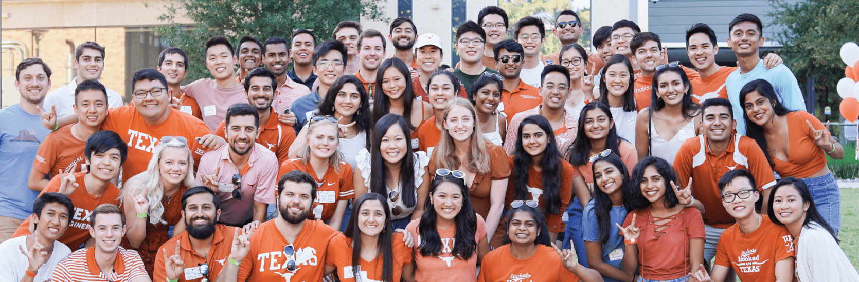 smiling group of Texas engineers outside wearing UT Austin t-shirts