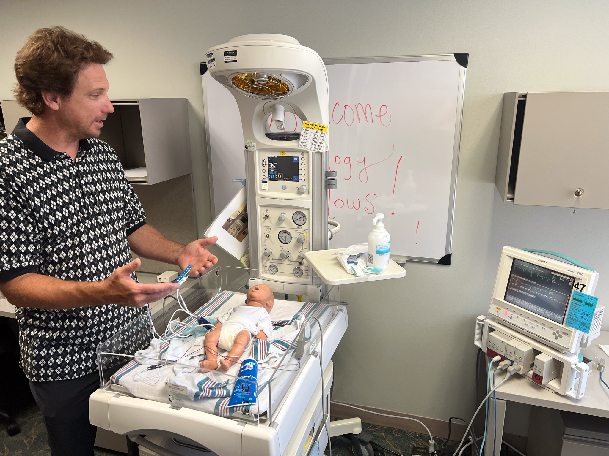 Mechanical engineering professor Chris Rylander with a model baby for research