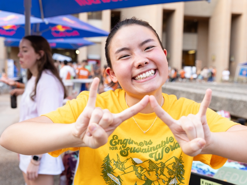 Texas engineering student doing WEP hook'em hand sign