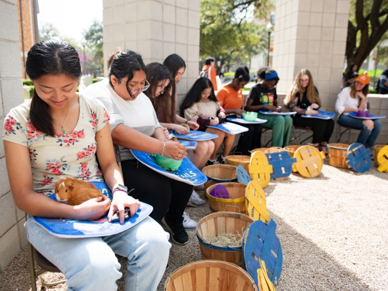 Texas engineering students holding small animals