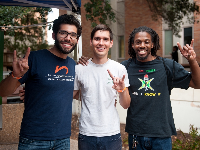 Texas engineering students from student organizations smiling and doing hook 'em horns