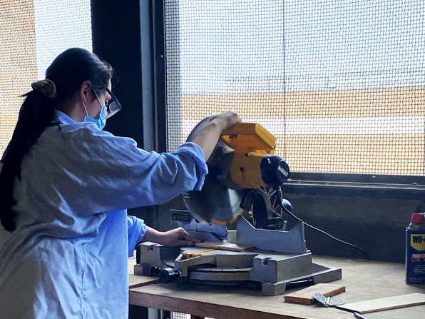 Cockrell student operating a buzz saw