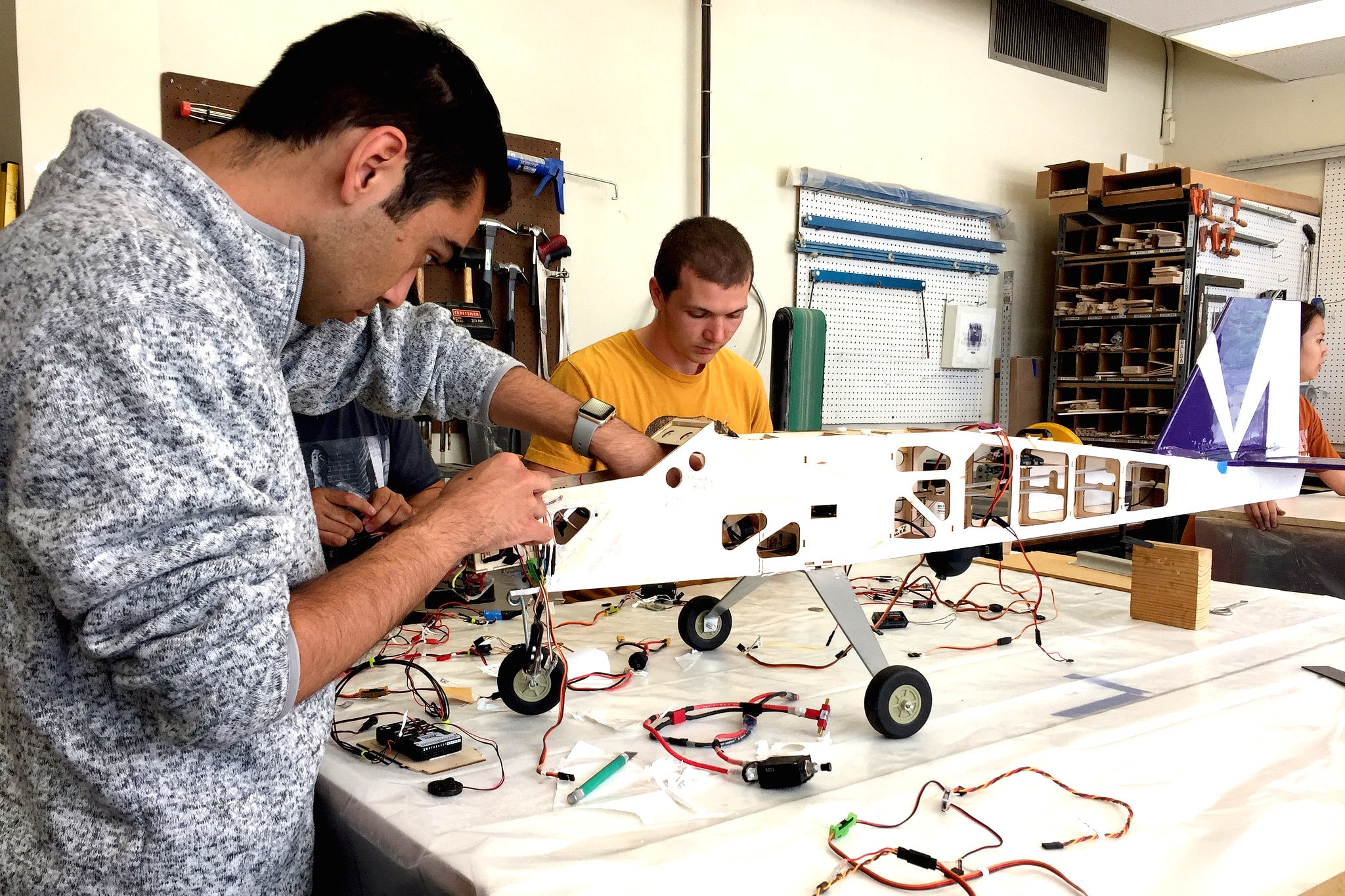 students working on a rocket prototype