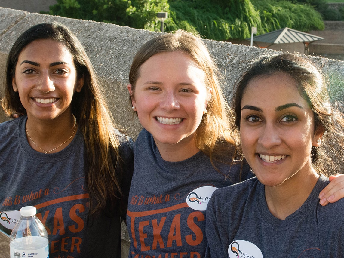 three women smiling wearing wep tshirts