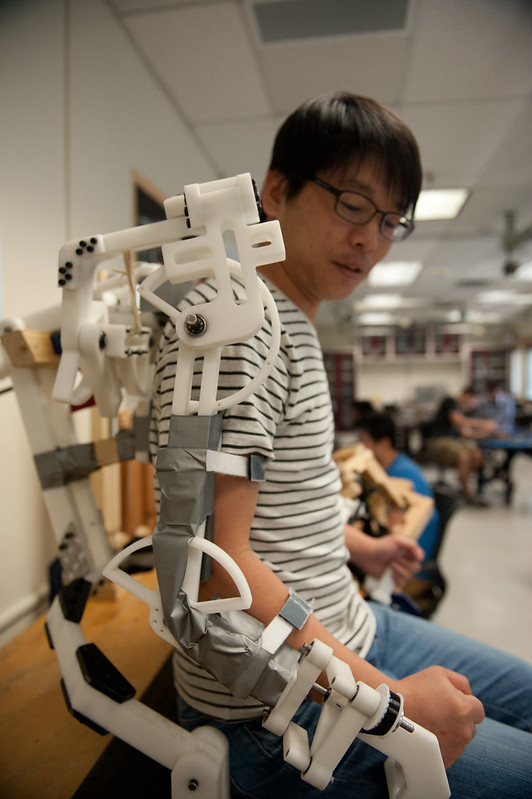 Texas Engineering student wearing robotic arm from RENU lab