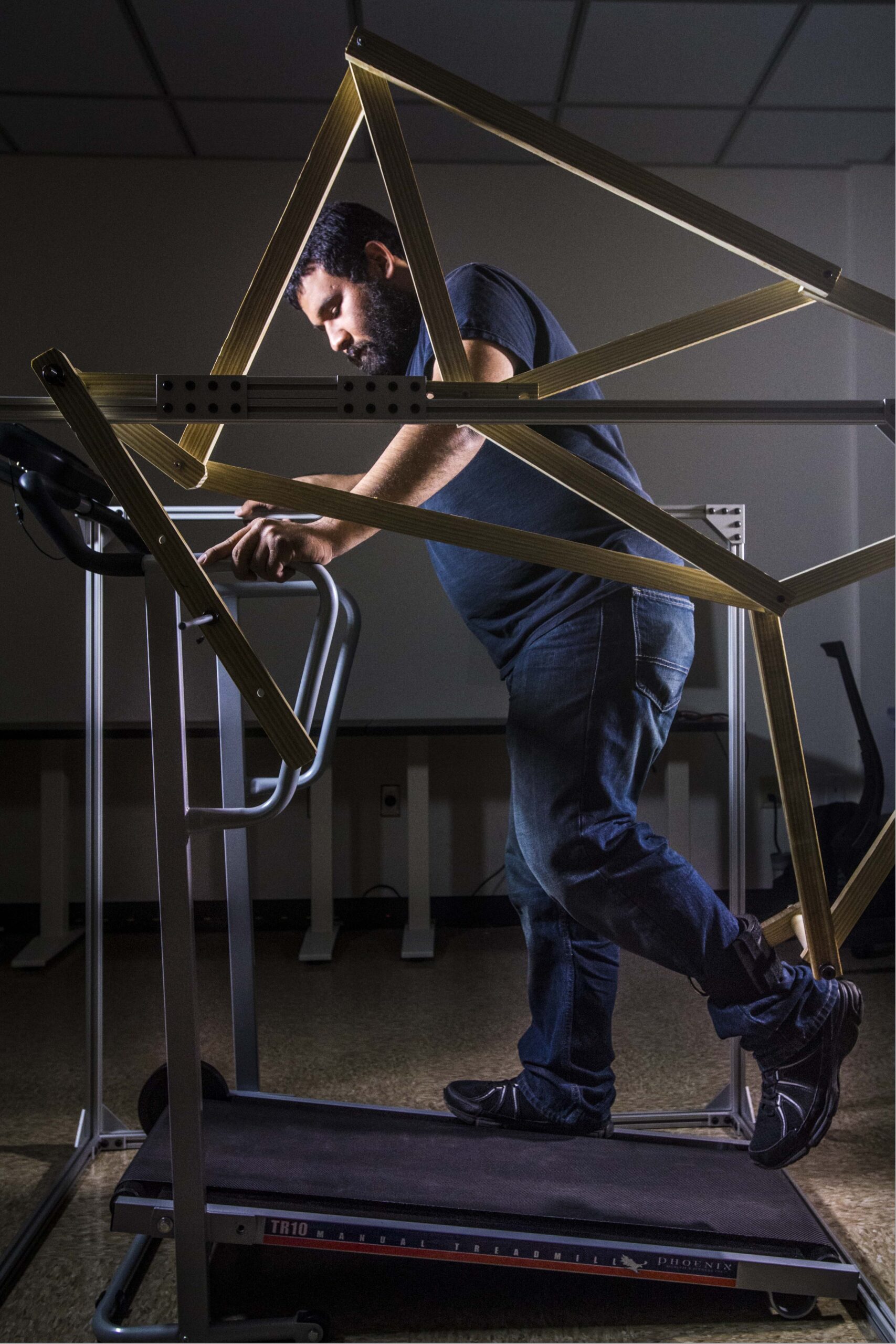 Mendez demonstrates the larger model of the robotic gait trainer. It applies complex knowledge of body kinetics to a low-tech solution for more affordable healthcare.