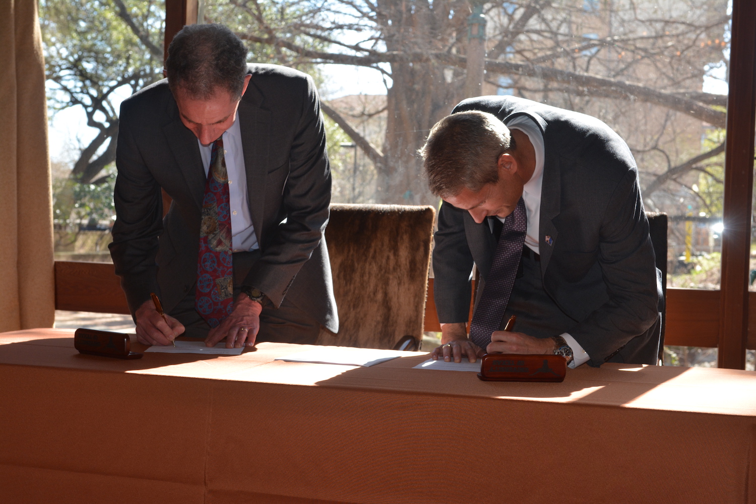 Lockheed Martin representatives bent over a desk writing on papers