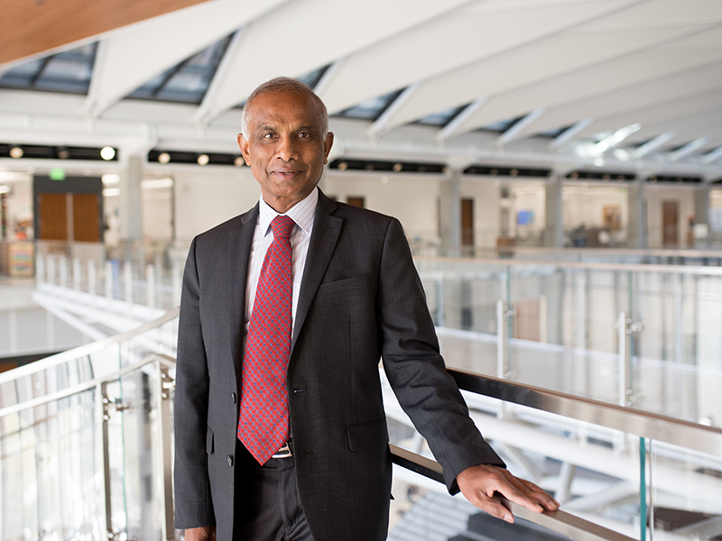 Arumugam Manthiram at the top of the spiral staircase inside of the Engineering Education and Research Center.