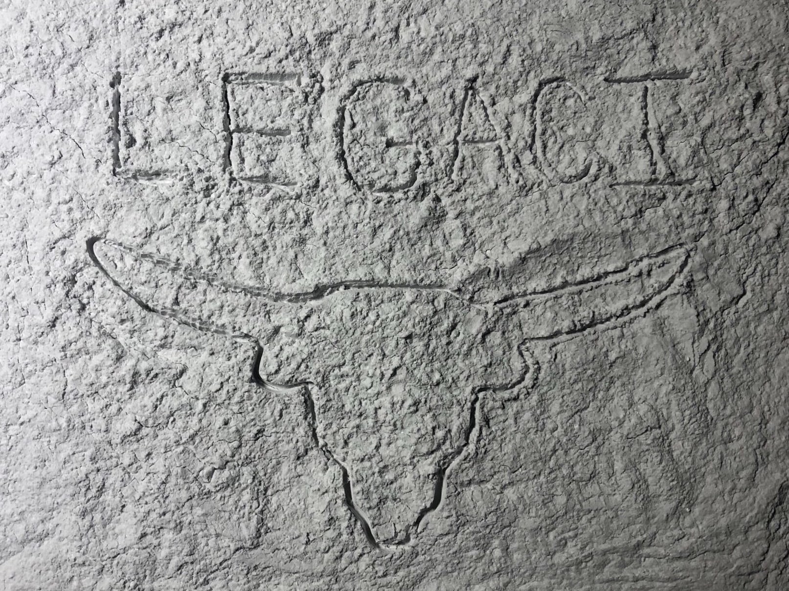 LEGACI text with UT longhorn outline written on the moon's surface