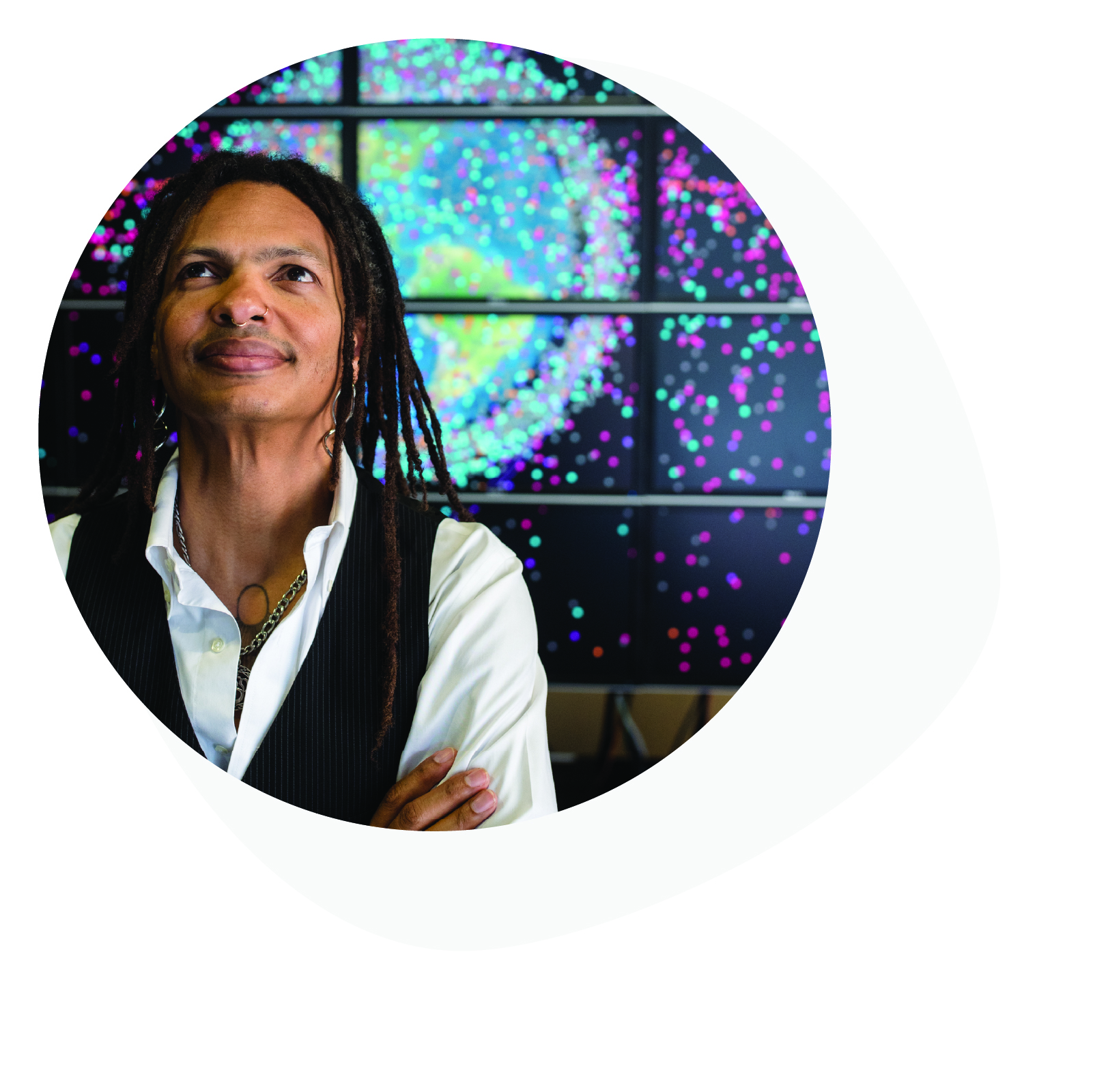 Moriba Jah stands in front of screen depicting global research