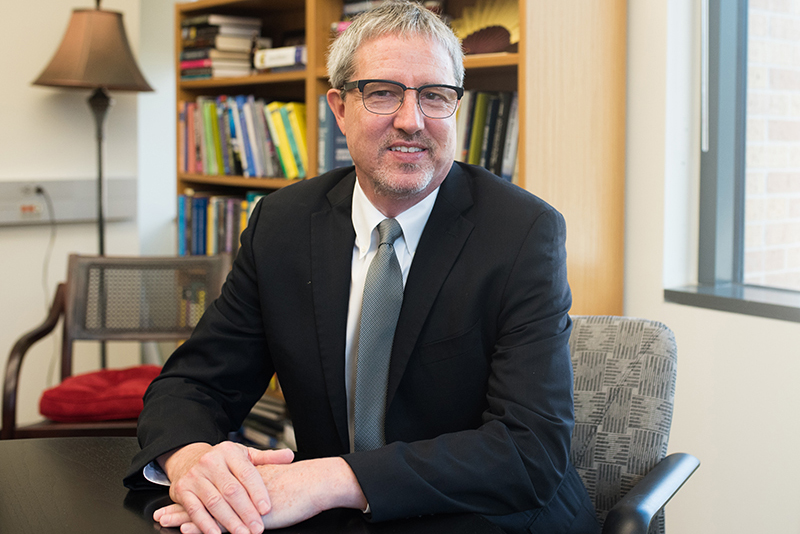 Clint Dawson smiling at his desk
