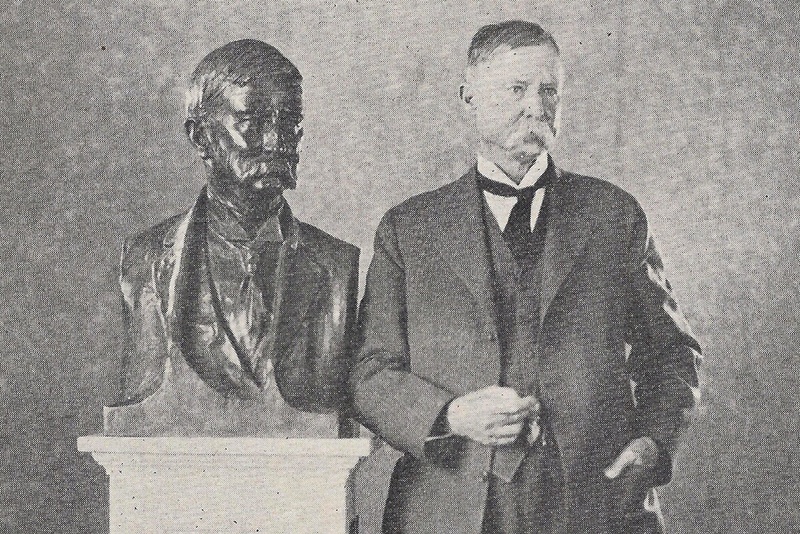 Texas Engineer Thomas U. Taylor standing next to bust of himself