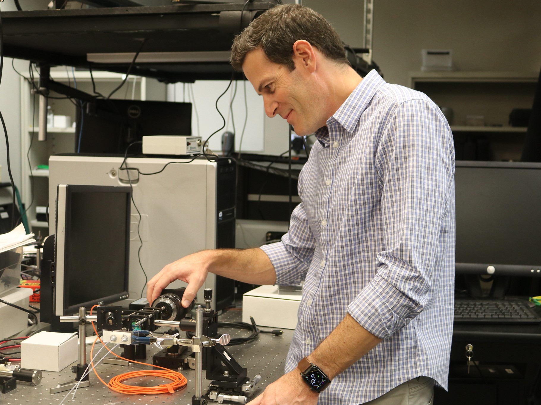 James Tunnell smiling while working on research project in his lab