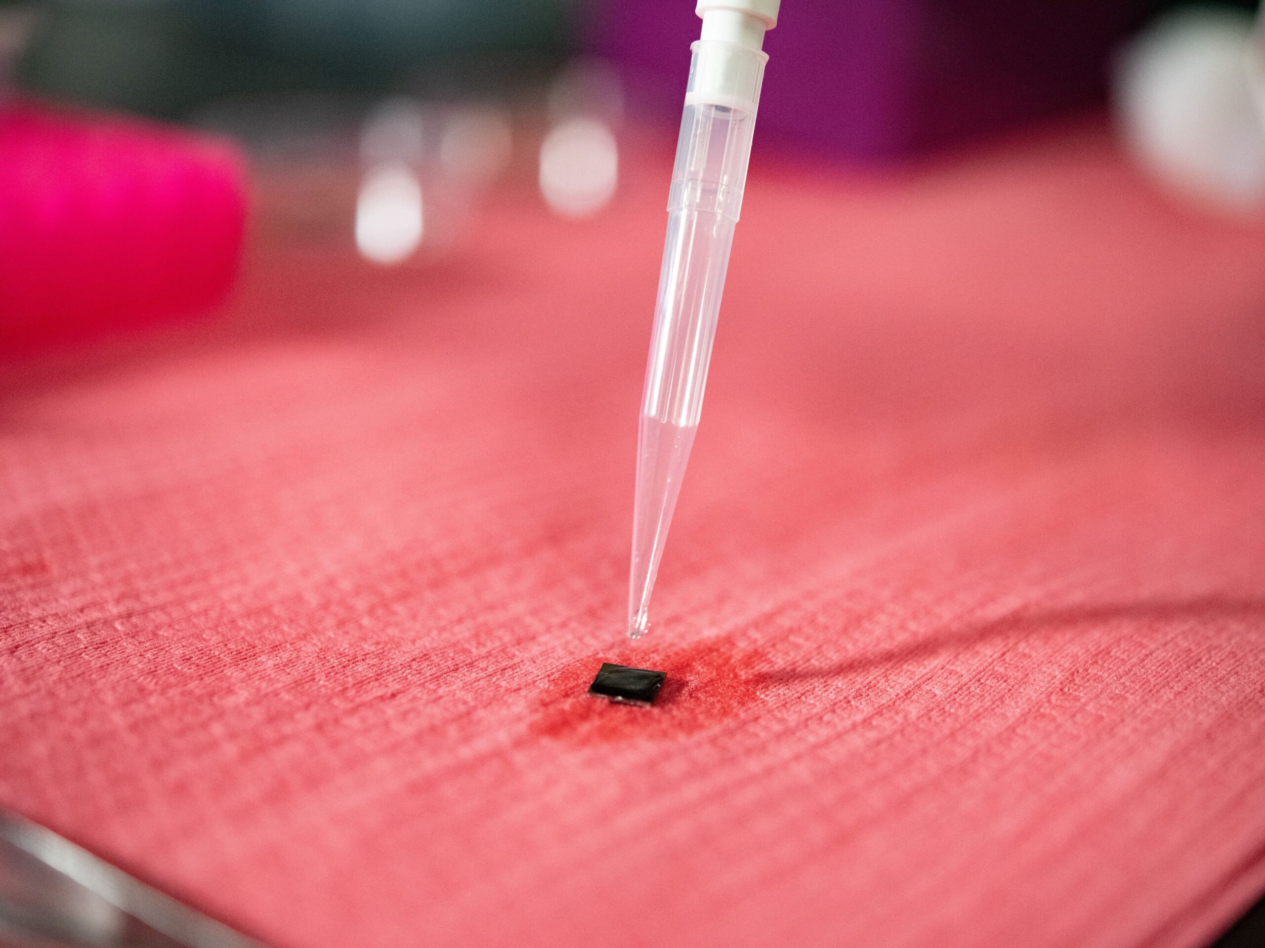 Water dropper dripping liquid onto small square material