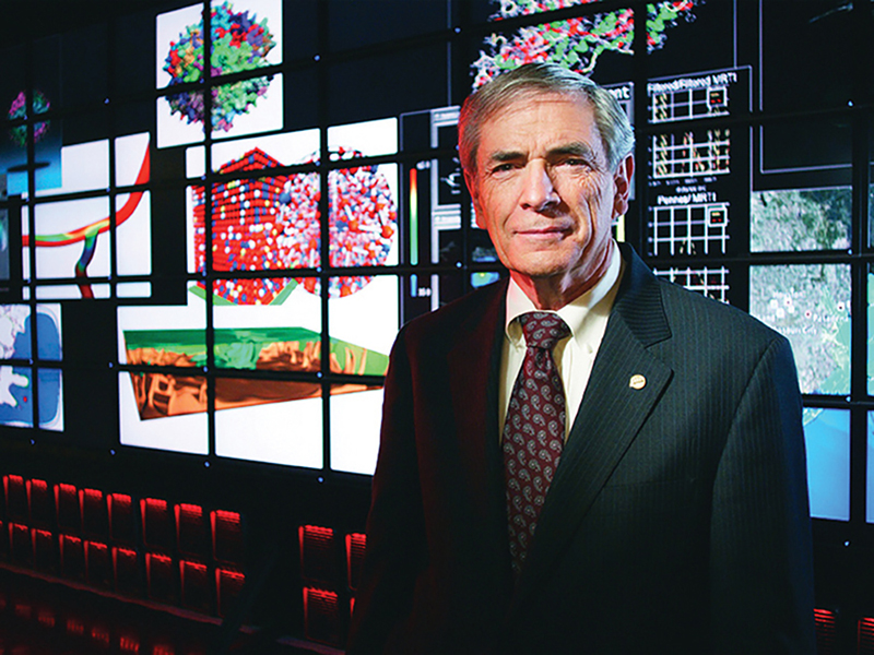 J. Tinsley Oden standing in front of lit up monitors