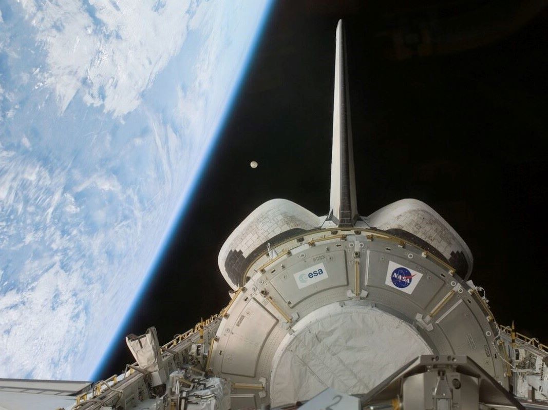 spacecraft orbiting earth with NASA logo