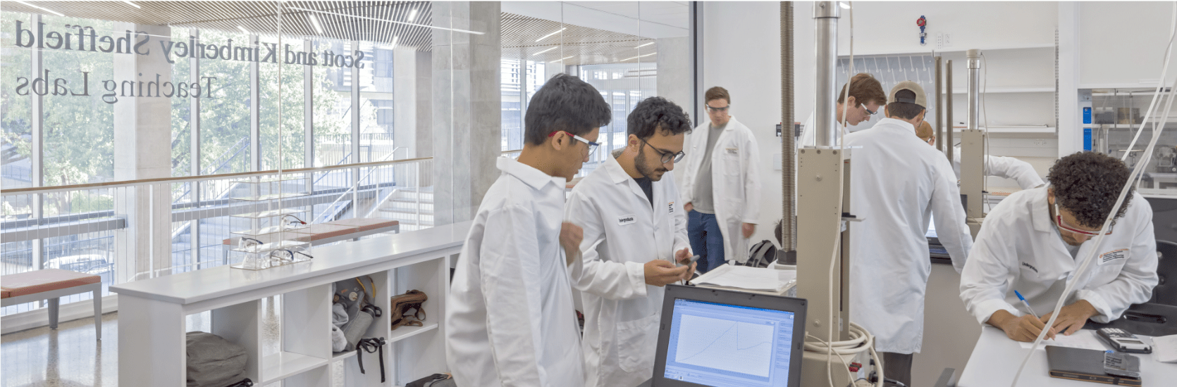 scientists in white lab coats in lab