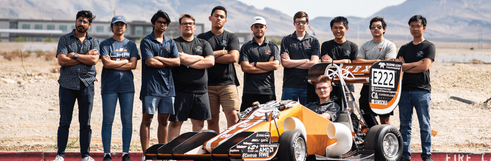 team of cockrell engineers standing by race car they made