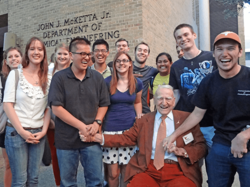 Texas Engineer students gathered around John McKetta and smiling