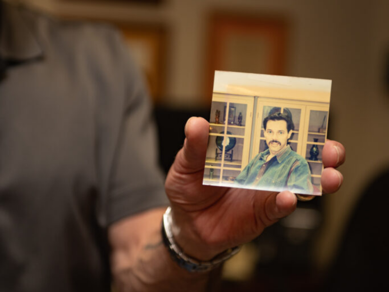 Texas Engineer Glen Baum holding an old photograph of himself