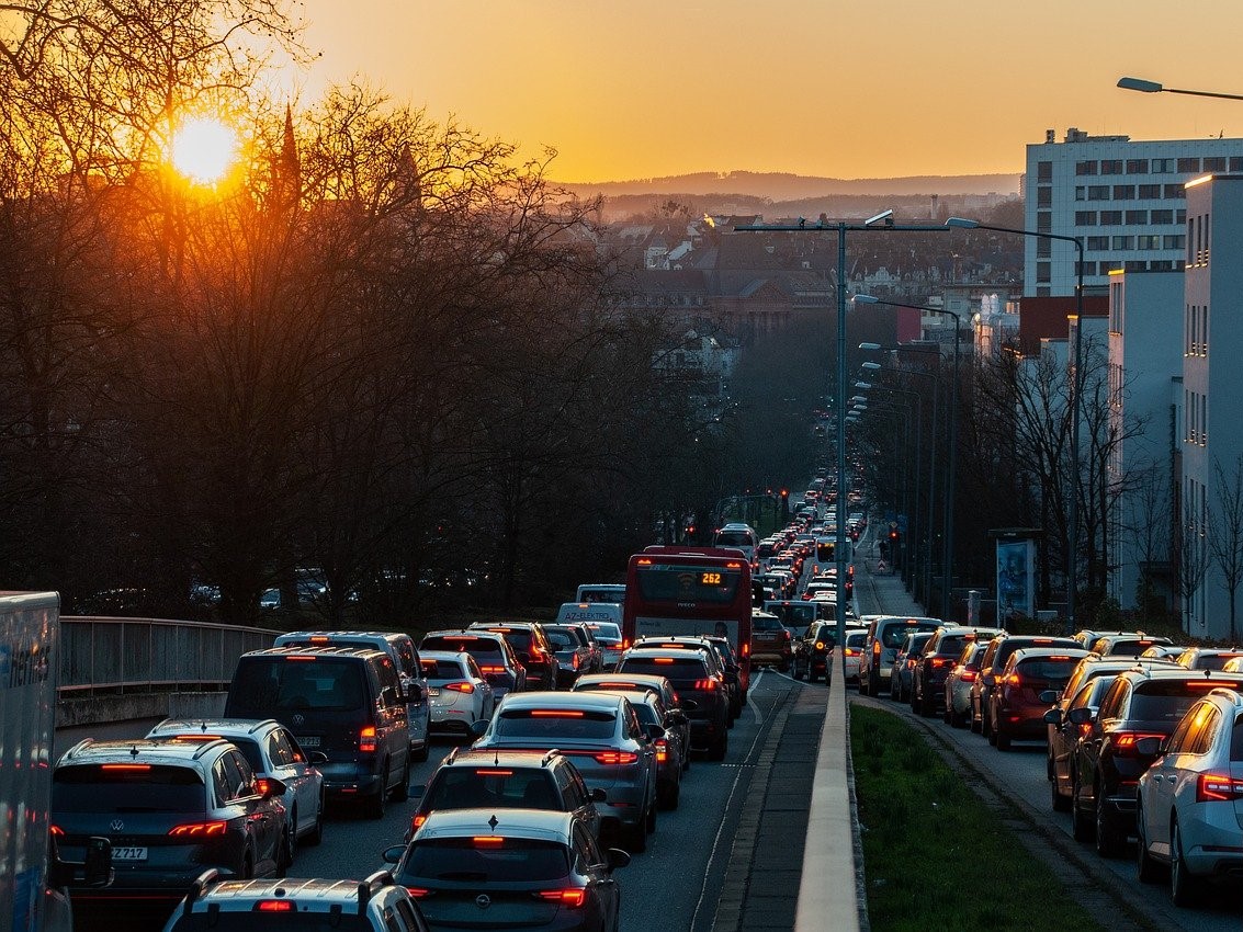 Traffic on a busy city road at sunset