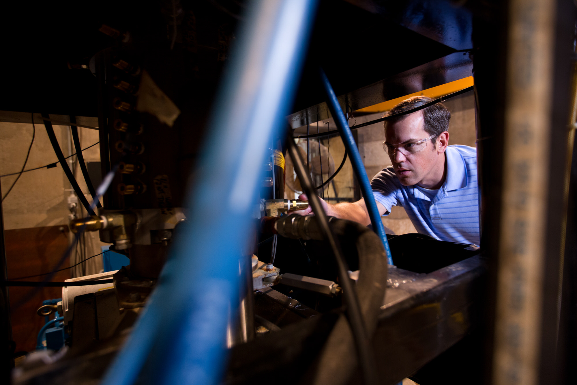 Man working on pipes and wires at Pickle Research campus
