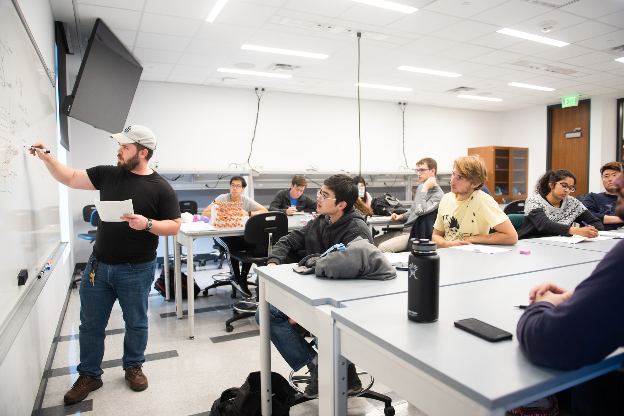 TMI classroom where professor teaching students at whiteboard