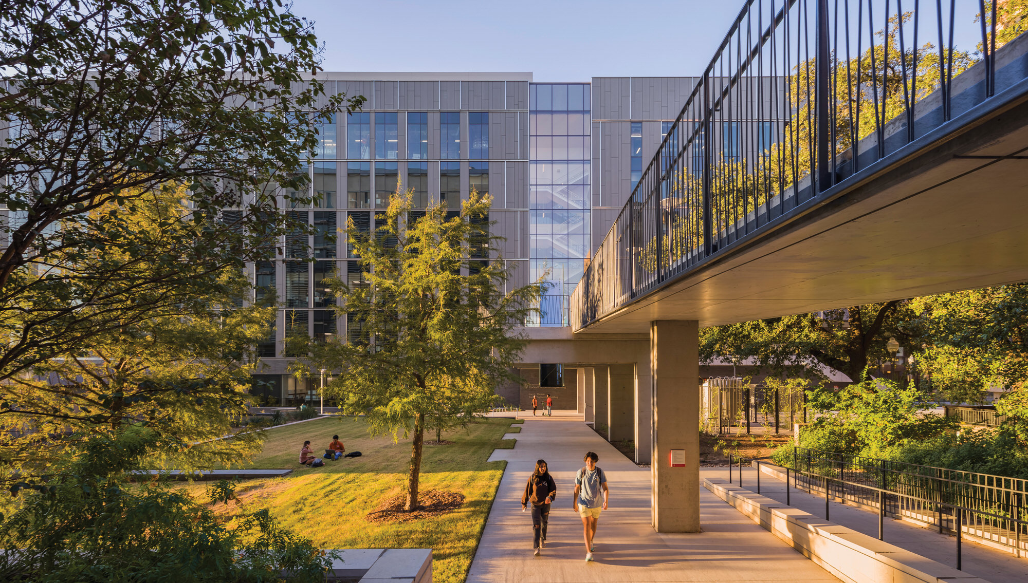 Students walking along bridges outside GLT building.