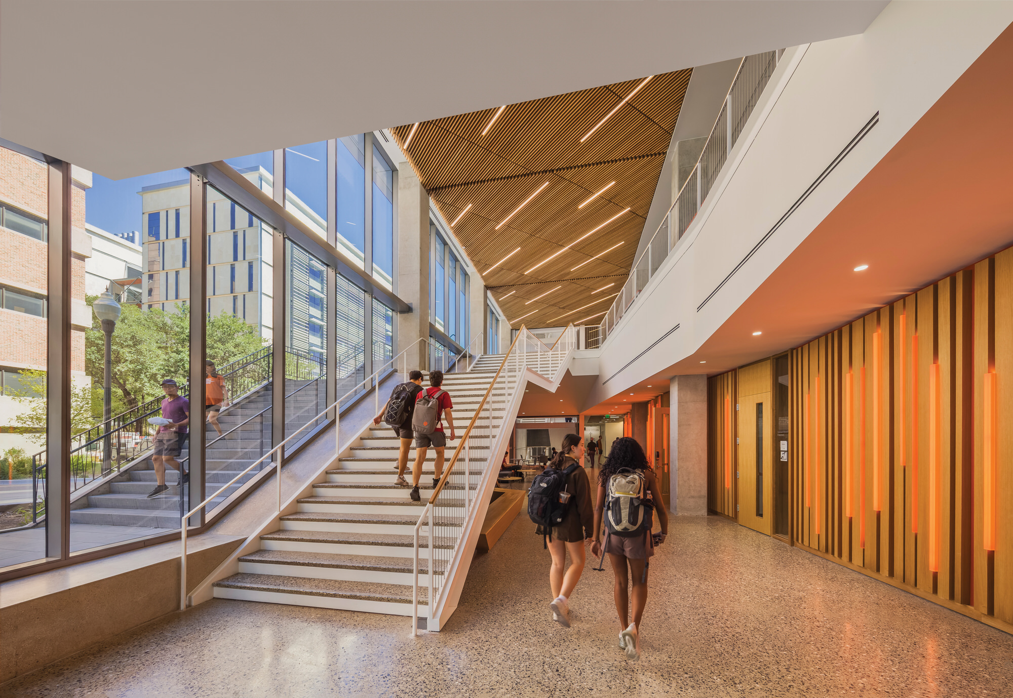 Students walking up main stairwell of Gary L Thomas Building