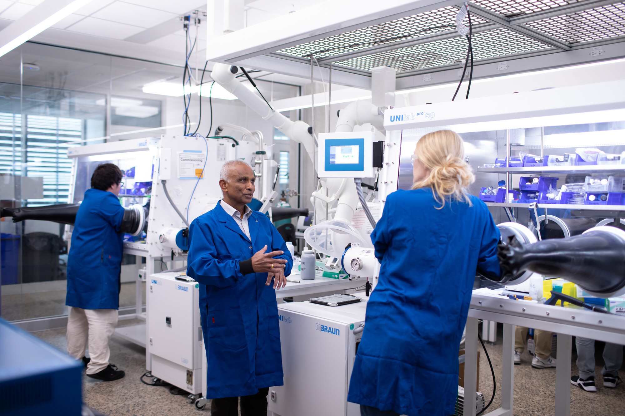 Ram Manthriam discusses research with graduate student in battery lab.