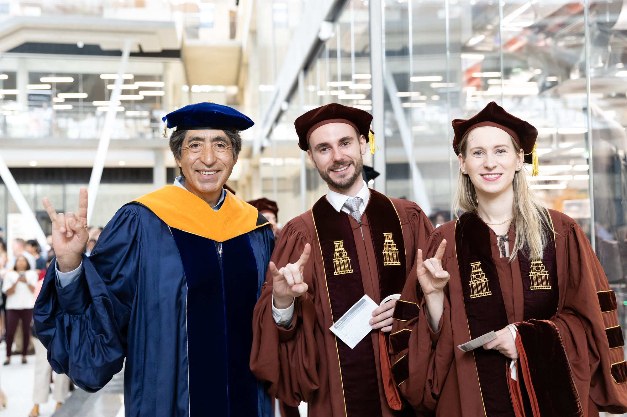 Graduate students at Commencement with faculty advisor.