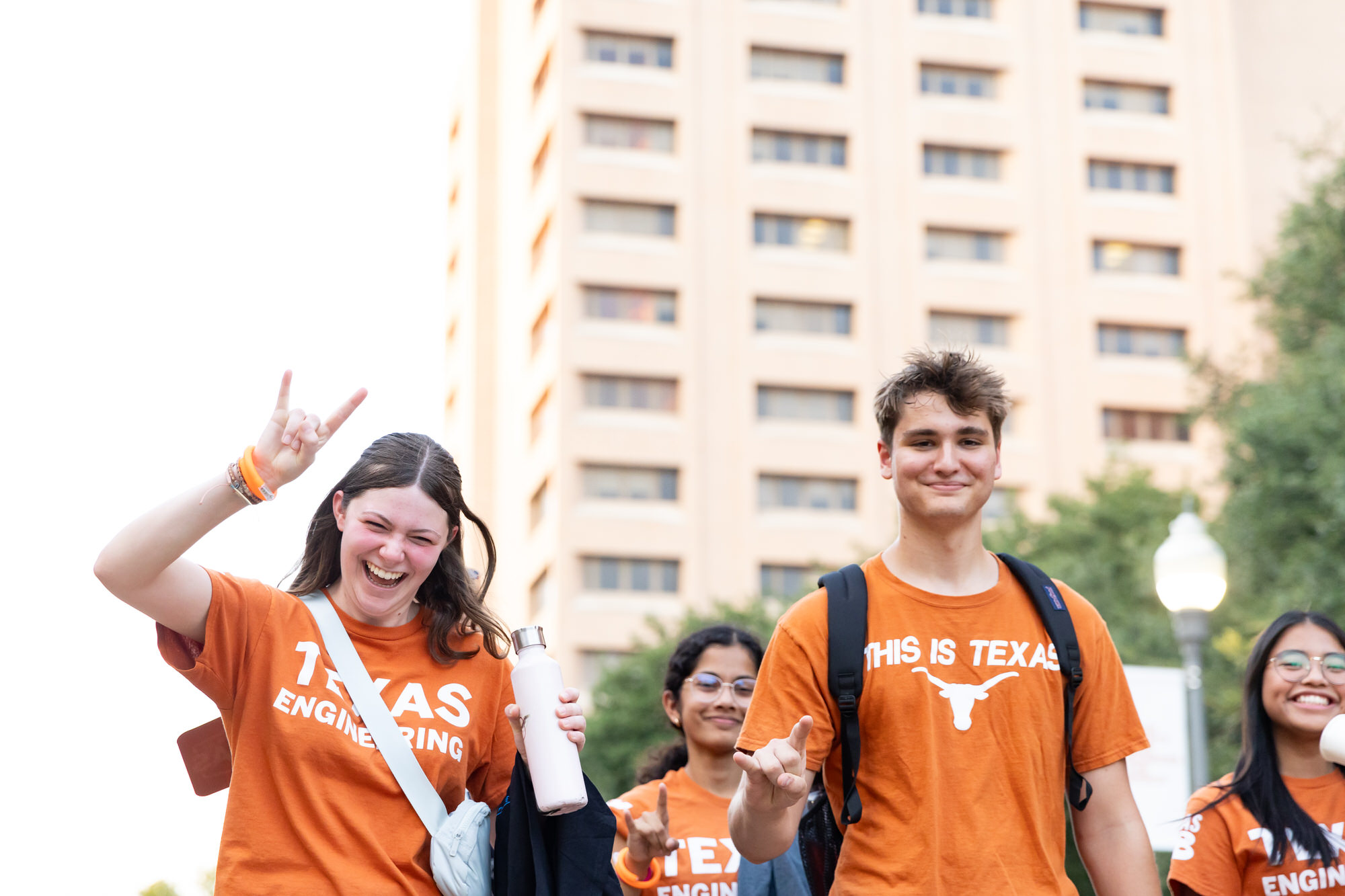 Students give hook 'em while walking past camera