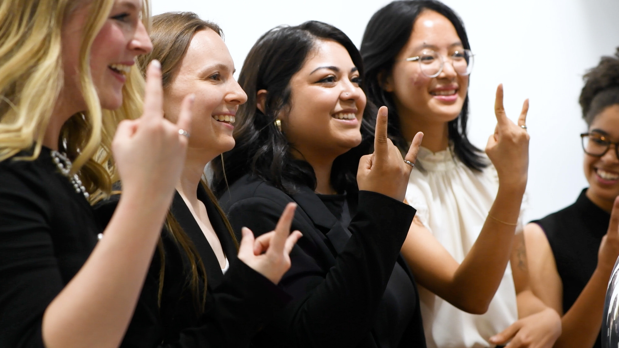 Students participating in Order of the Engineer Ceremony, smiling and showing off rings.