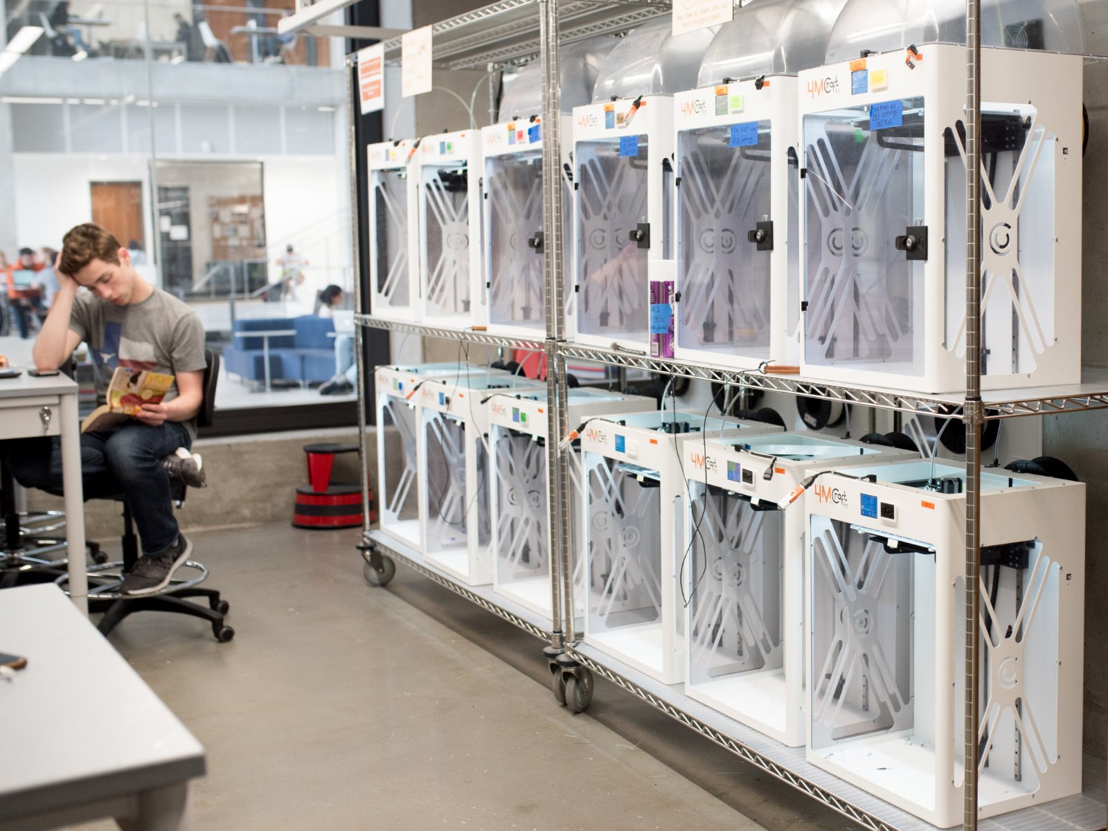 3D machines inside Inventioworks as student studies nearby.