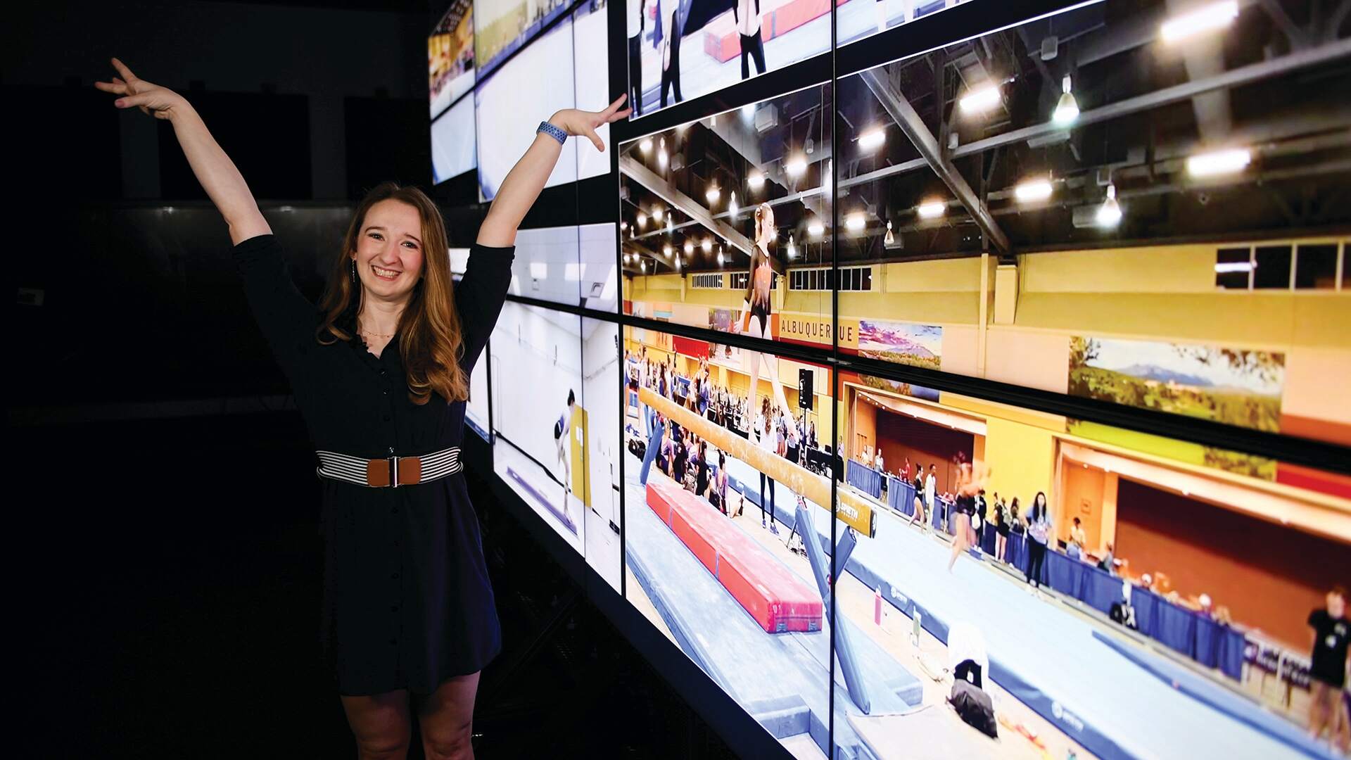 Ella Small in poses with her gymnastics competition video in background