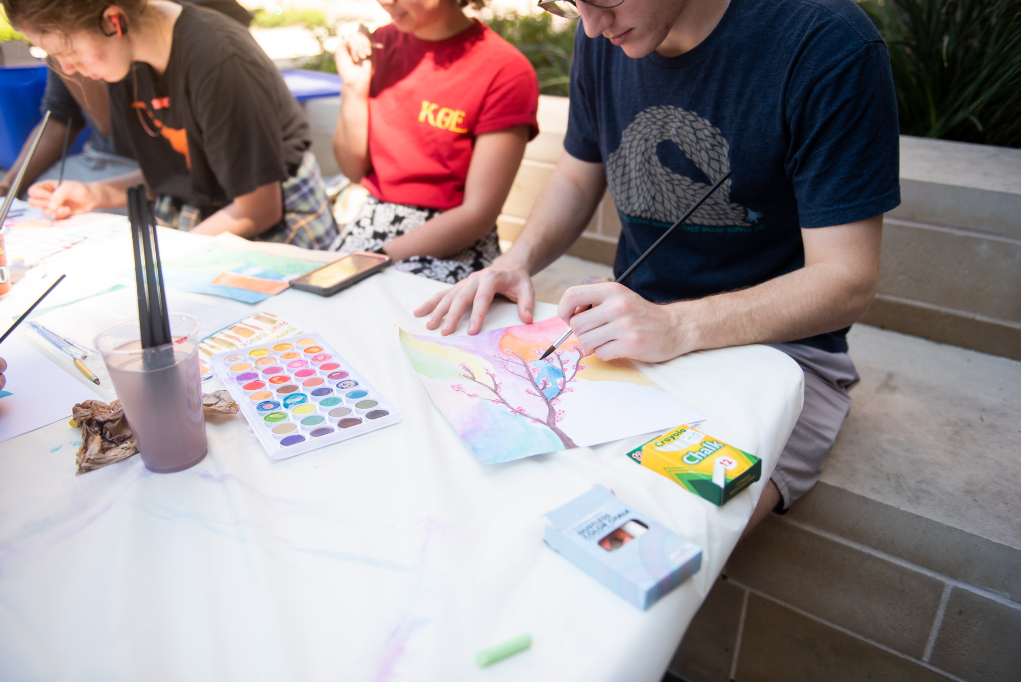 students painting at a wellness program event