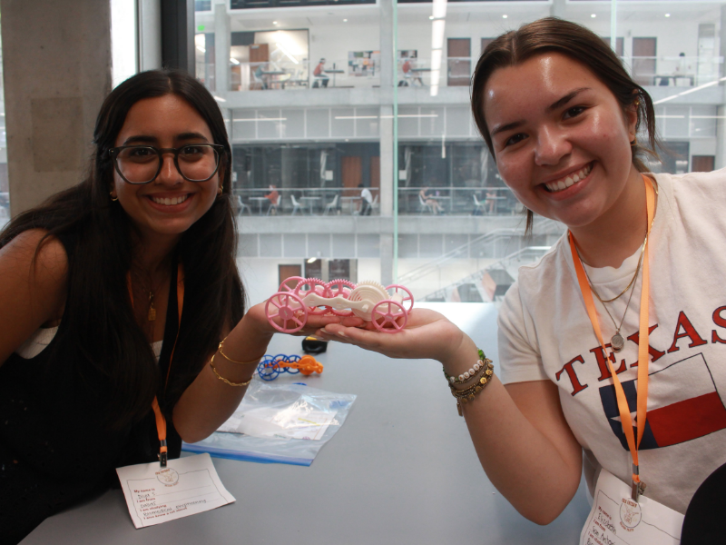 Texas Engineering students holding project prototype in Texas Inventionworks