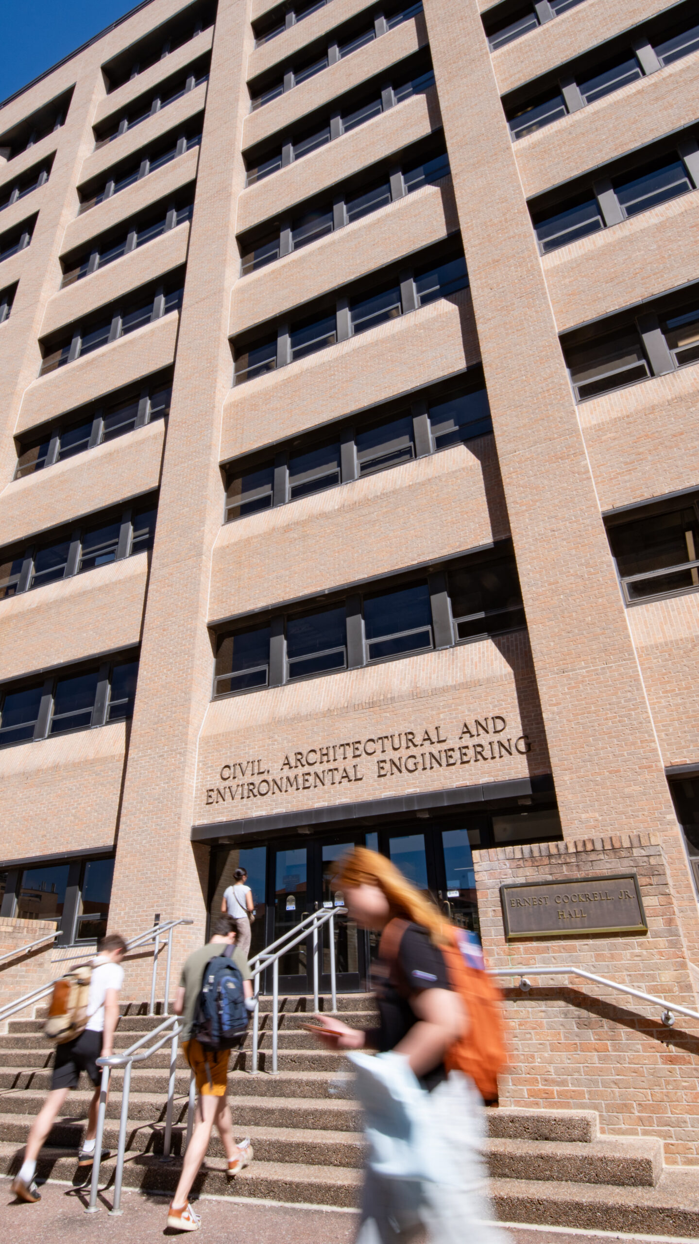 Students walking in and out of ECJ building
