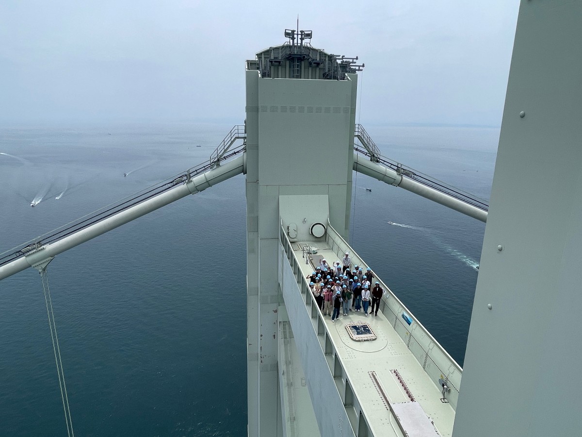 A cohort of UT students and Professor of Practice Gregory Brooks, tour the Akashi Kaikyo bridge with Satoshi Kashima while in Japan for the Emerging Technologies study abroad program.